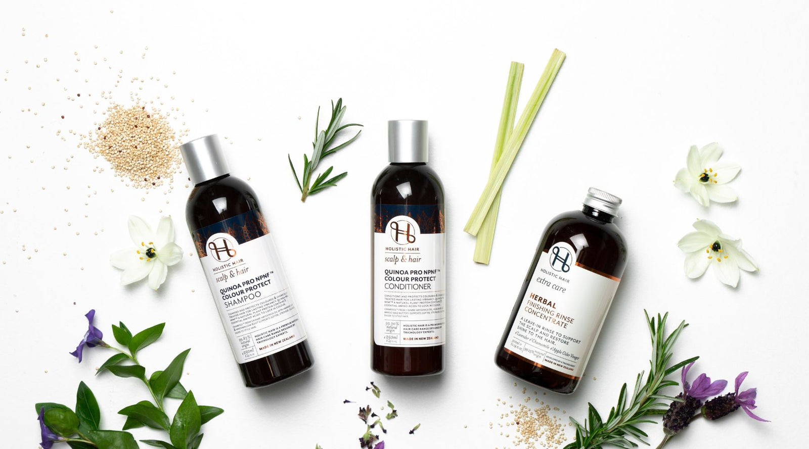 Quinoa Pro Shampoo & Conditioner with Herbal Finishing Rinse Concentrate on a botanical background. 